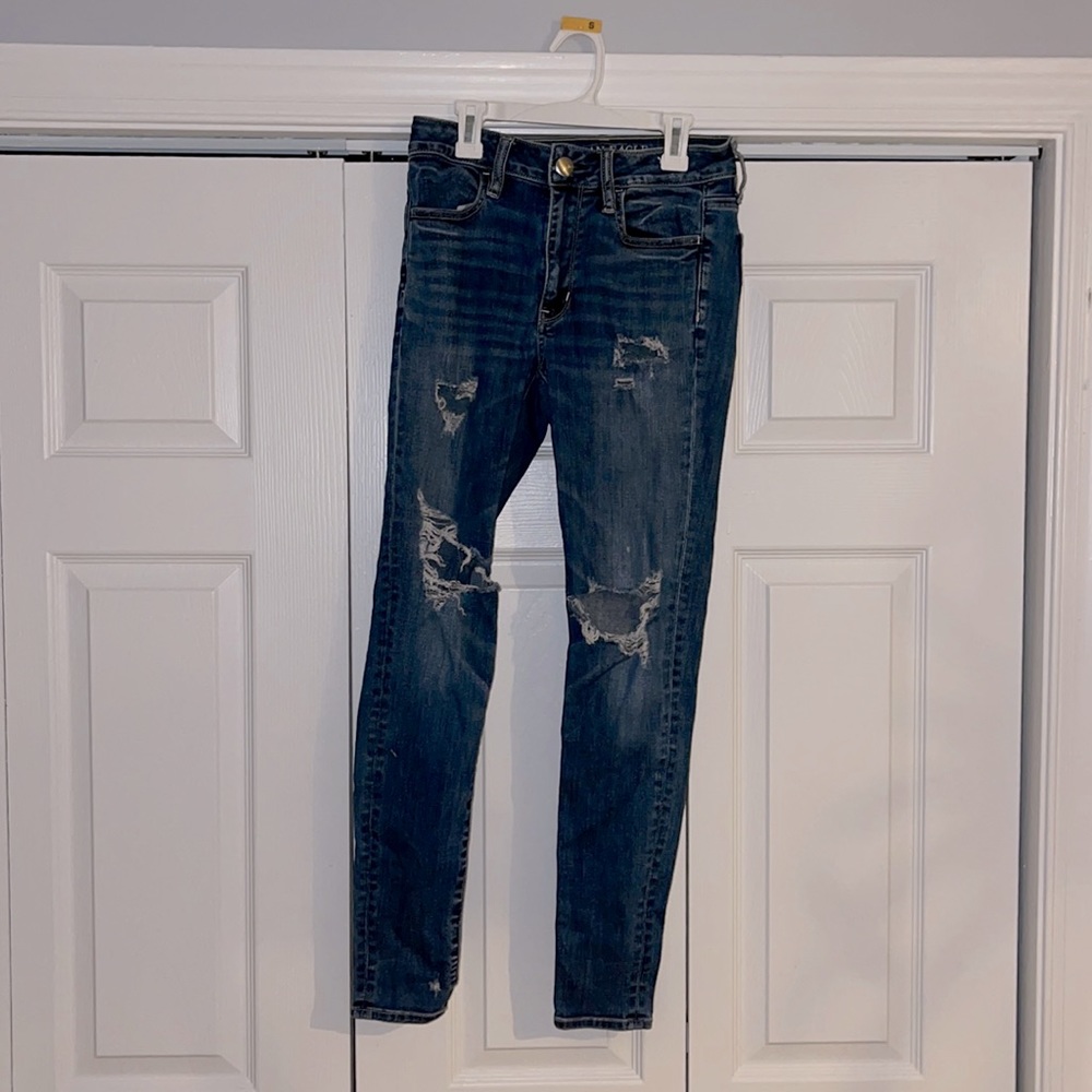 Dark wash mid rise ripped skinny jeans